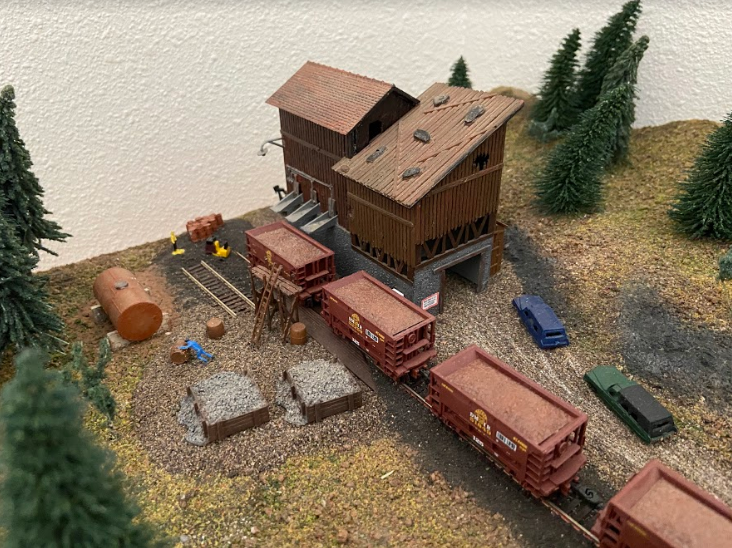 Image of model train landscape with ranch, trees and outbuildings.