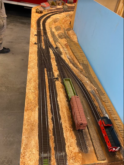 Image of model train tracks being prepared for installation.